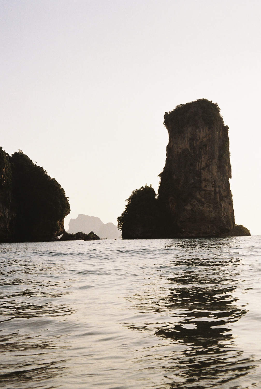 A karst rock silhouette in a misty sea
