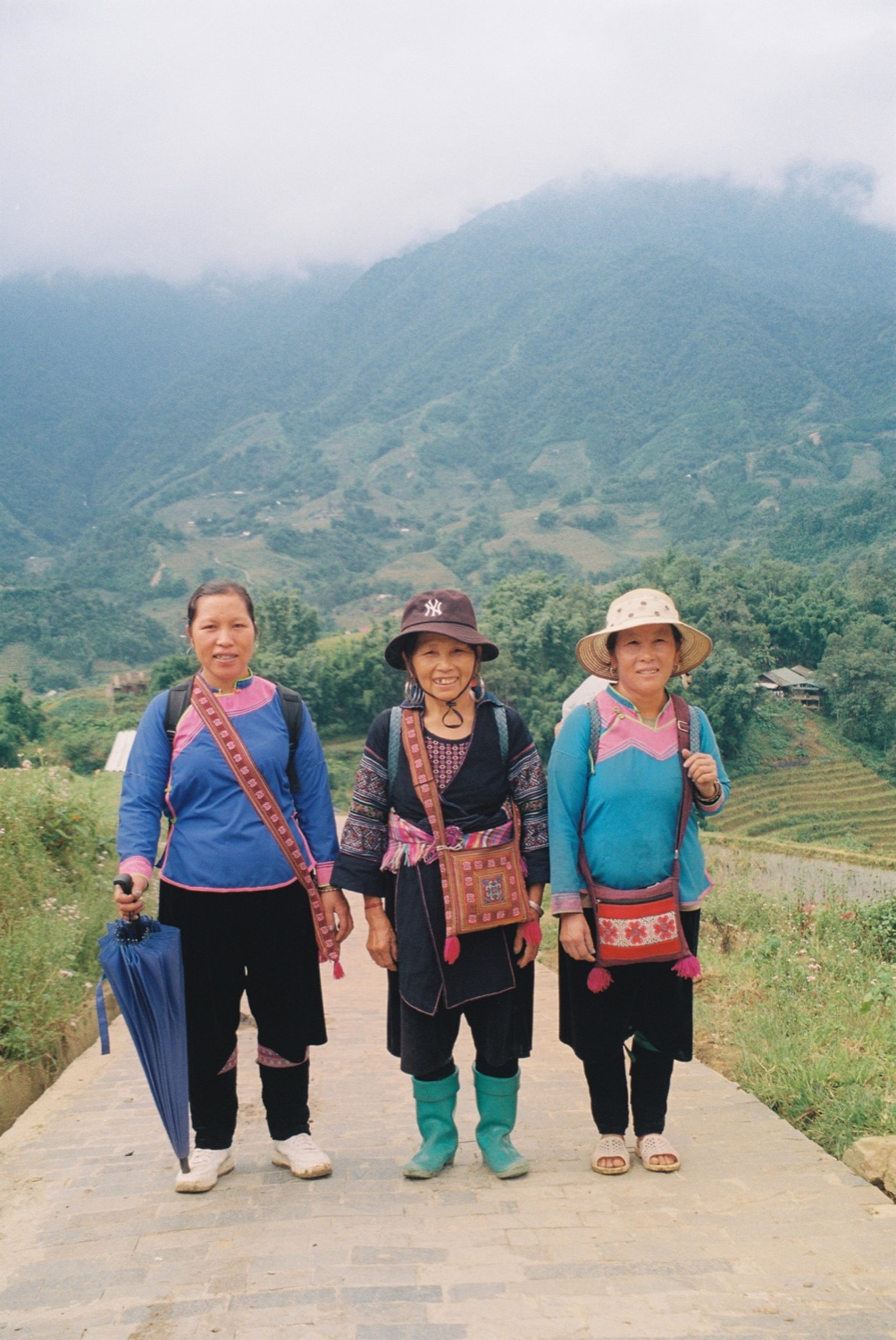 Three Hmong women on a path in the rice terraces